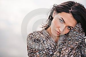 Natural beautiful dreamy female posing against lake with blowing hair. Portrait of romantic female looking at the camera enjoying