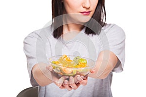 natural beautiful young woman heaving a healthy fruit meal, isolated on white