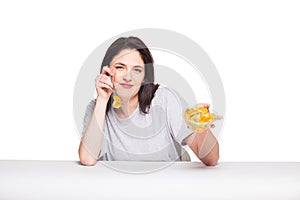 natural beautiful young woman heaving a healthy fruit meal, isolated on white