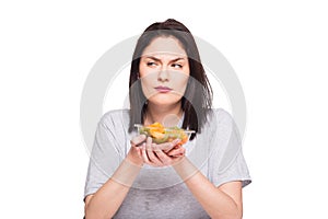 natural beautiful young woman heaving a healthy fruit meal, isolated on white