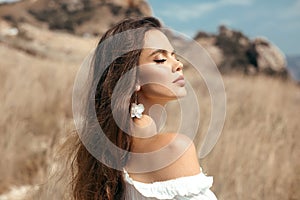 Natural beauty brunette outdoor portrait. Beautiful young bride woman with long wavy hair enjoying in the hay field.  Romantic