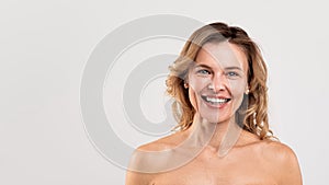 Natural Beauty. Portrait Of Attractive Smiling Middle Aged Woman With Naked Shoulders