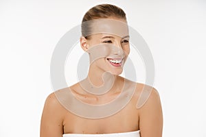 Natural Beauty Portrait. Beautiful Spa Woman smiling isolated over white background. Perfect Fresh Nude Skin