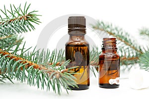 Natural beauty remedy. Small bottle of essential pine oil, pine tree twigs, alternative medicine