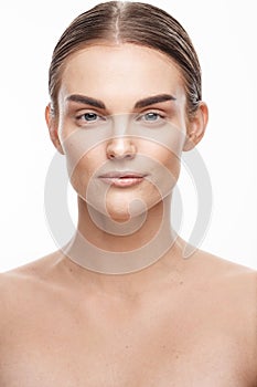 Natural beauty and skincare concept. Portrait of beautiful female model with clean face isolated on white background