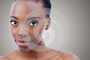 A natural beauty. Studio shot of a beautiful african american model isolated on gray.