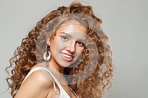 Natural beauty. Young happy woman redhead fashion model with long natural healthy brown curly hair