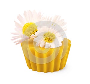 Natural beeswax cake block and flower isolated on white