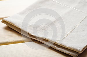 Natural beige cotton cloth on wooden table