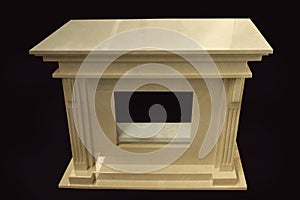 Natural beige marble fireplace with mantelpiece on black background, top view front