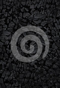 Natural black activated charcoal texture for backgrounds. Top view