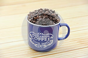 Natural black coffee beans and ceramic blue a mug