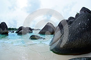 Natural black rock formation on the seashore at the beach in Belitung Island.