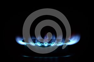 Natural blue gas is burning on dark background