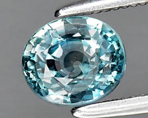natural blue green sapphire gem on the background photo