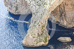 Natural blue grotto with speedboats, Malta photo