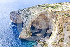 Natural blue grotto with speedboats, Malta photo