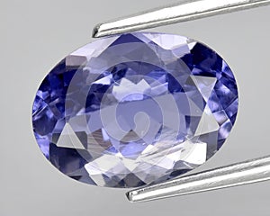 natural blue iolite gem on the background