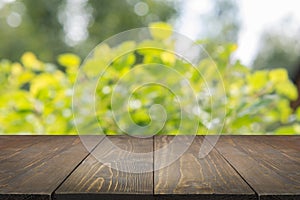 Natural bokeh abstract background with wooden board.