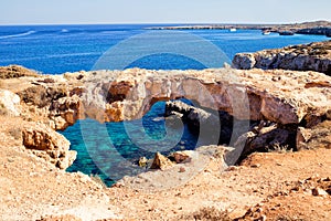 Natural bridge in Cavo Cape Greco, at National Forest Park