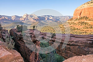 Natural bridge in front of valley view in arizona desert