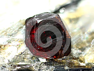 Natural bright red crystal of garnet-spessartine mineral photo