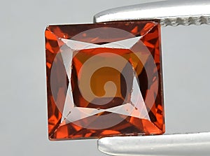 natural brown orange grossular garnet gem on the background