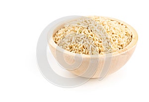 Natural brown uncooked rice in wooden bowl