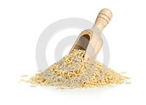 Natural brown uncooked rice in wooden scoop