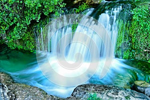 Natural cascade water flows over the rocks to the lake, Portugal