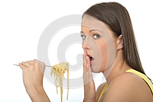 Natural Cautious Shocked Young Woman Holding A fork Full of Cooked Spaghetti Pasta photo