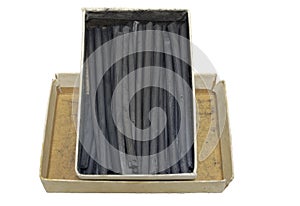 Natural charcoal sticks in vintage cardboard box. isolated, clipping path