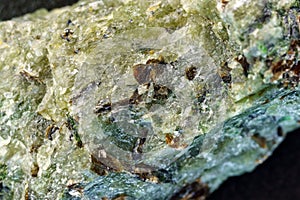 Natural chrysolite, olivine green color transparent raw crystal, close up, macro