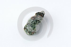 Natural chrysolite, olivine green color transparent raw crystal, close up, white background