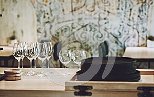 Natural clay brown plates, glass goblets and wooden saucers in a cafe. Porcelain dishware on wooden table. No plastic, zero waste