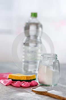 Natural cleaner. Vinegar, baking soda, salt, lemon.homemade grey wooden background