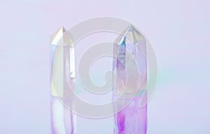 Natural clear crystal quartz electroplating rainbow on holographic background. Meditation, reiki and spiritual healing concept