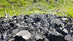 Natural coals with grass on background