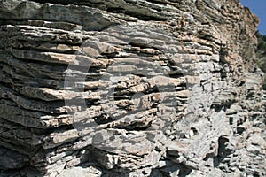 Natural coastal rock formation surface rough material close up textured wall