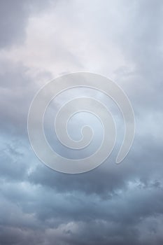 Natural color dramatic dark blue cloudy sky with wavy rippling clouds aligned above horizon, taken with wide angle 35 mm lens