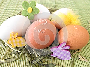 Natural colored eggs in easter nest photo