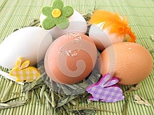 Natural colored eggs in easter nest photo