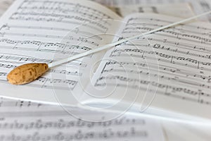 A natural conductors baton on orchestral score