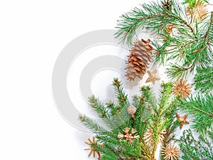 Natural coniferous branches and pine cones are decorated with straw decorations and bathed in the sun. Christmas, New Year concept