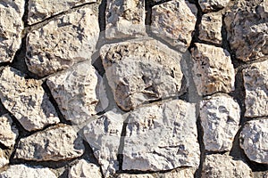 Natural contrast masonry wall stone granite is a pattern of texture, material and background with colored stones.