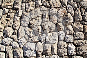 Natural contrast masonry wall stone granite is a pattern of texture, material and background with colored stones.