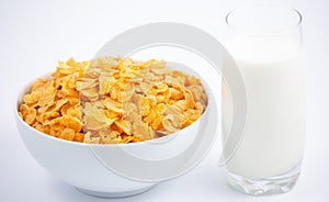 Natural corn flake breakfast cereal in cups and milk is a healthy breakfast that is good for your body every day on a white