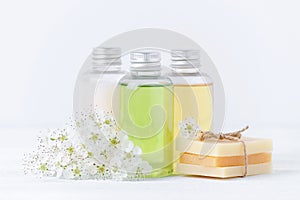 Natural cosmetic bottles and handmade soap bar with fresh flowers