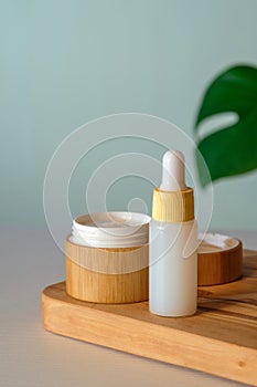 Natural cosmetic product set. Jar of organic moisturizer cream and body lotion in dropper bottle. SPA beauty products.