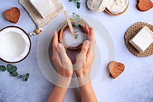 Natural cosmetic products setting with soaps and fresh herbs top view woman hands